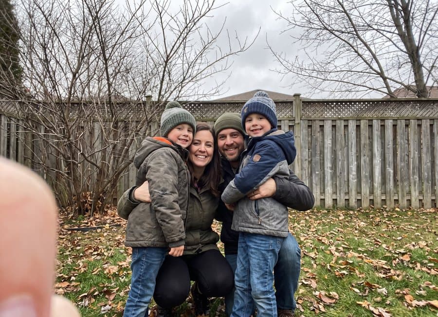 A family of four in a back garden on an overcast day